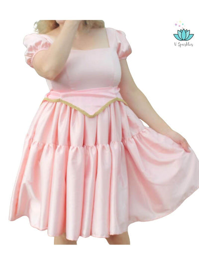 Aurora's Enchantment Adult Dress – Perfect for Halloween and Disneybounding – Transform into Princess Aurora with this elegant pink and blue dress, ideal for Halloween parties, Disneybounding, or special occasions. Available in mid-size and plus-size options.