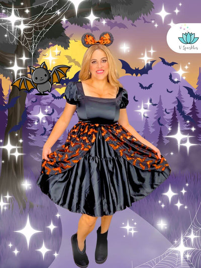 Black Dress with Black and Orange Overskirt – Bat-Inspired Halloween Costume – This striking black dress paired with a black and orange overskirt is perfect for a bat-inspired transformation. Ideal for Disneybounding, Halloween costumes, or themed events. Available in mid-size and plus-size options.