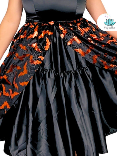 Black Dress with Black and Orange Overskirt for Adults – Perfect for Disneybounding – This bold black dress, combined with a bat-inspired black and orange overskirt, creates a spooky look perfect for Disneybounding or Halloween parties. Available in mid-size and plus-size options.