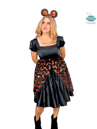 Orange Bat Halloween Adult Dress Set – Easy Bat Costume Transformation – This orange bat-inspired dress set offers an effortless transformation into a spooky bat, perfect for Halloween parties or Disneybounding adventures. Available in mid-size and plus-size options.