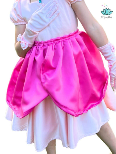 Pink Princess Video Game Dress-Up Overskirt for Girls – Perfect for Disneybounding and Pretend Play – This Princess Peach-inspired overskirt is perfect for young girls who love video game characters. Ideal for Disneybounding, birthday parties, and holiday celebrations.